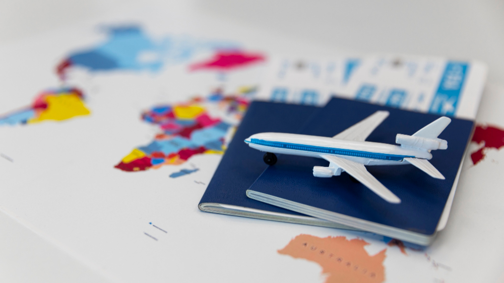 Modellflugzeug-liegt-auf-tickets-und-weltkarte